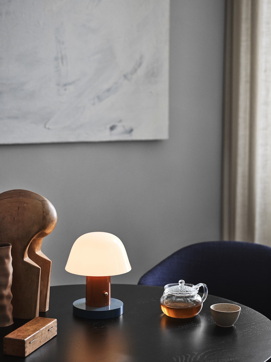 Setago Leuchte auf einem Tisch, daneben ein Kännchen Tee und eine kleine Teeschale.